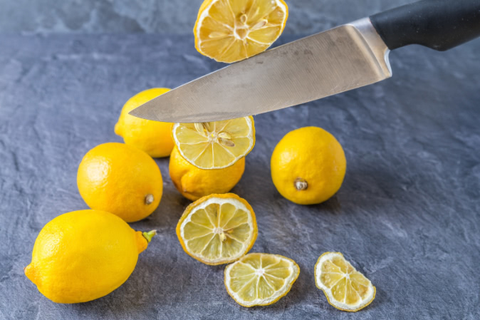 lemons and a knife on a countertop